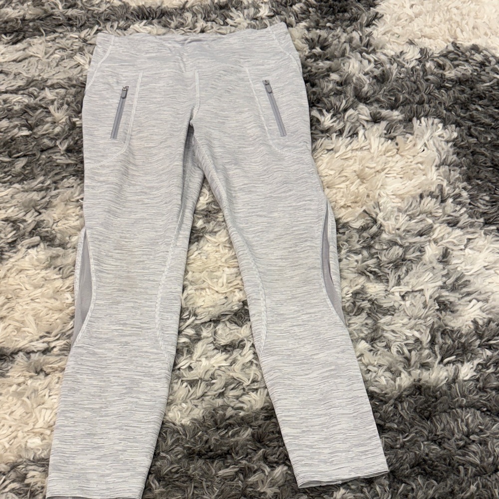 Lululemon Invigorate 7/8 Tight in a “Battleship Ice Grey" color.